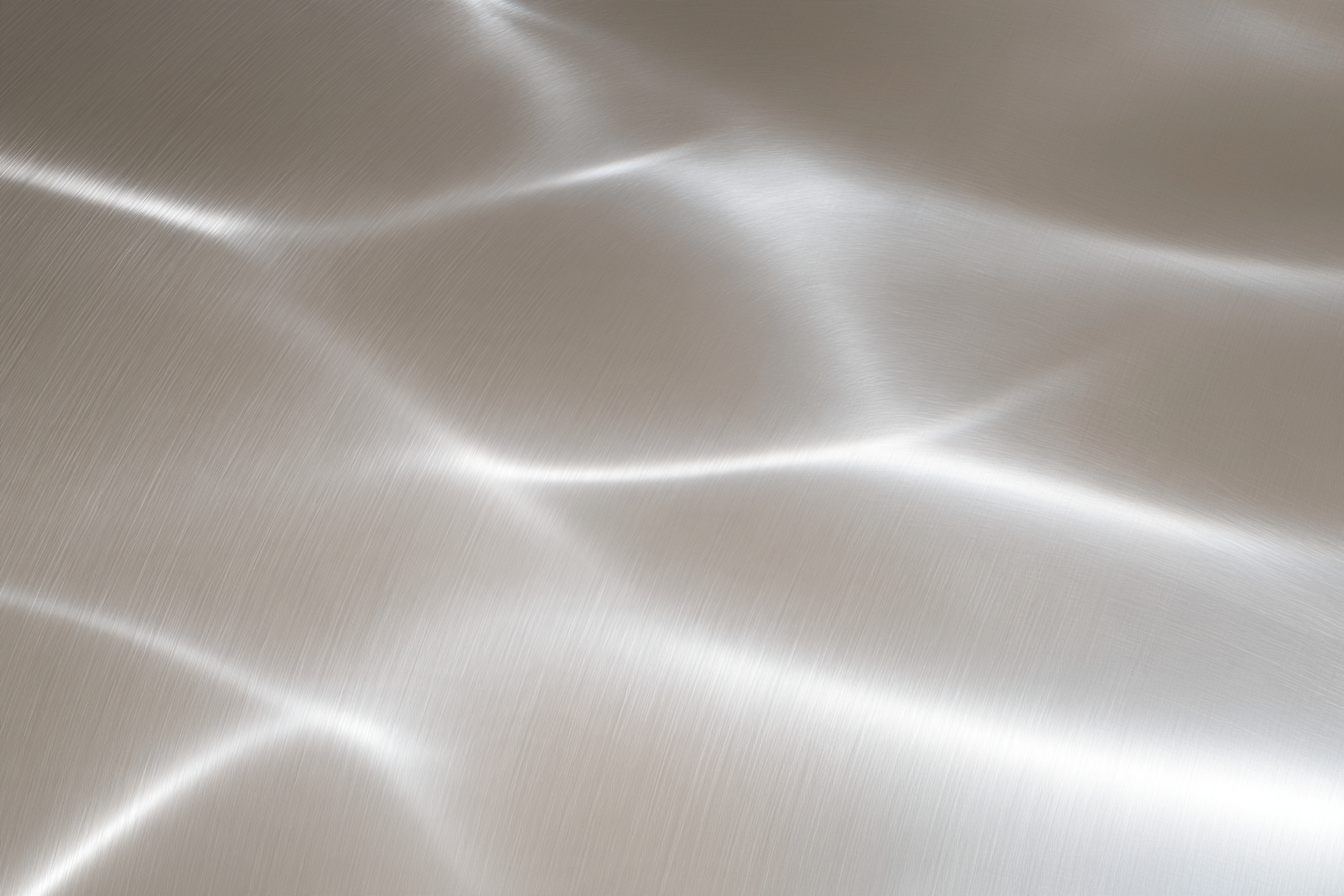 Light moving across a brushed anodized aluminium surface